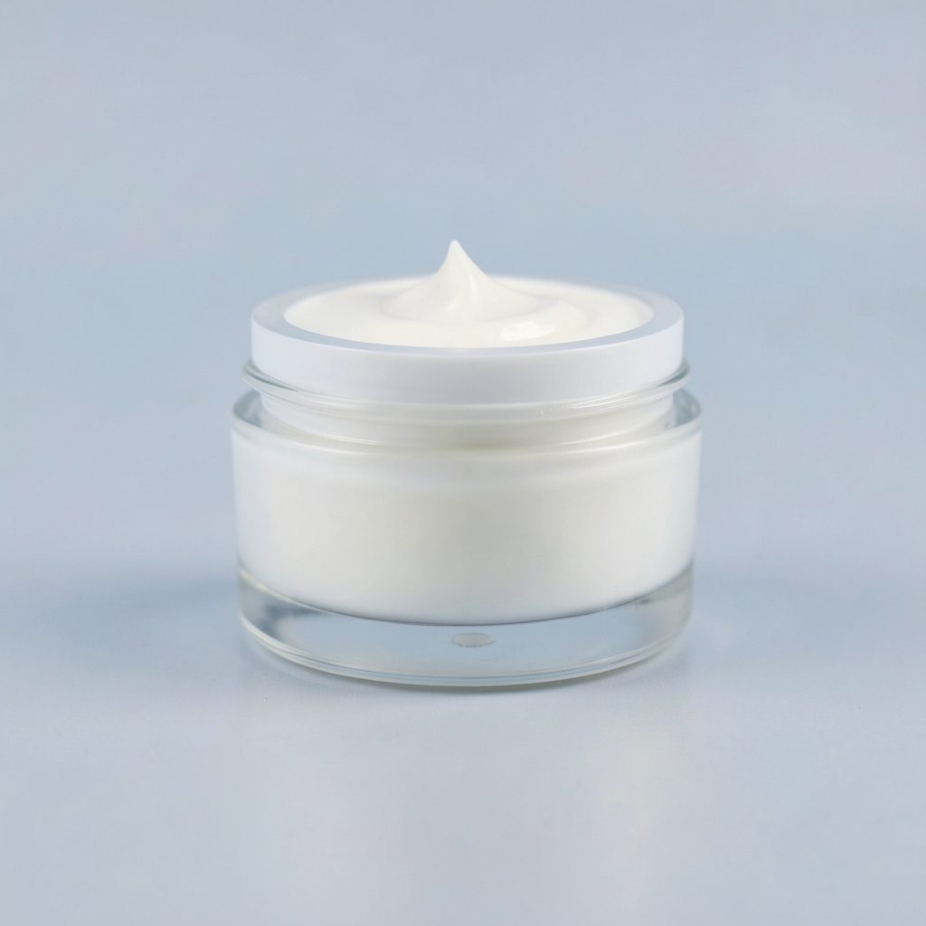 A single glass jar of white anti-aging face cream with a subtle sheen, centered on a clean soft-gray seamless backdrop, soft diffused lighting